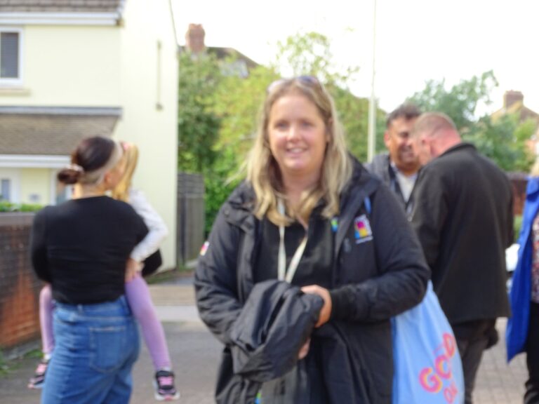 A Cornerstone colleague talking with residents at a community day