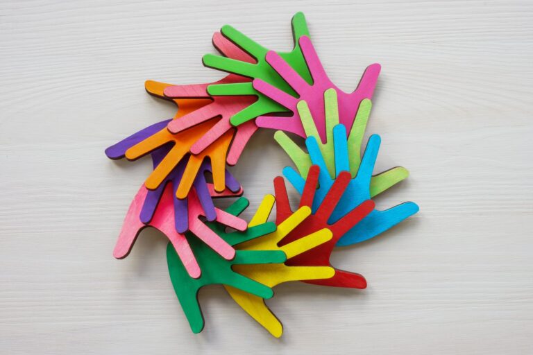 Brightly coloured paper hand cut outs arranged in a circle
