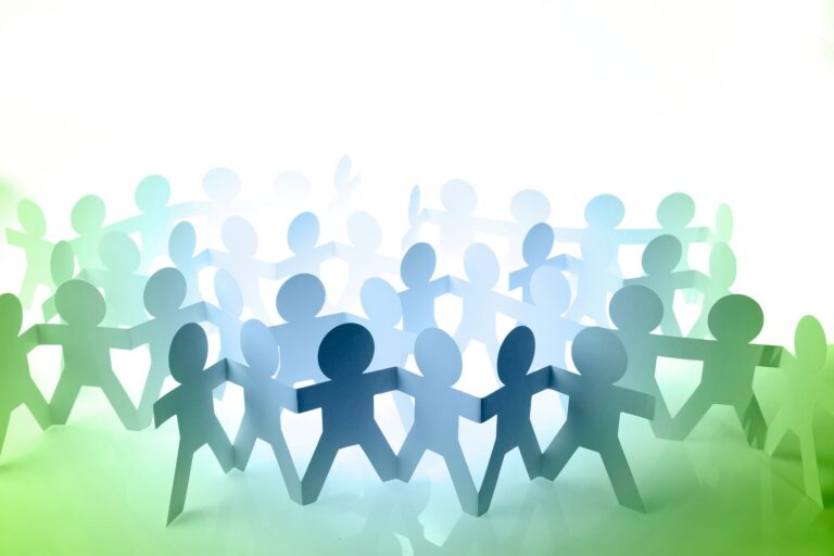 An illustration of a paper chain of cut out figures holding hands