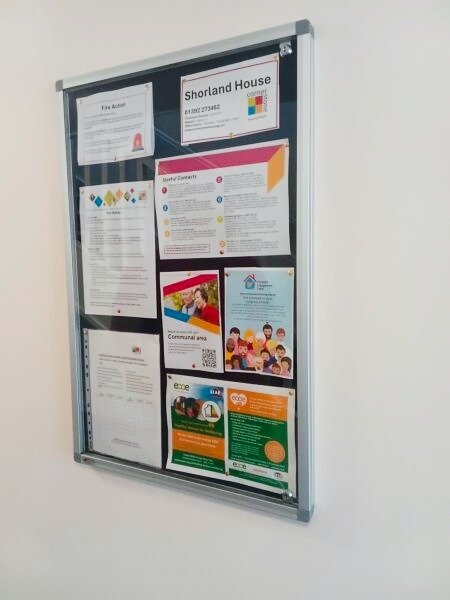 A communal noticeboard at Shorland House displaying resident information leaflets